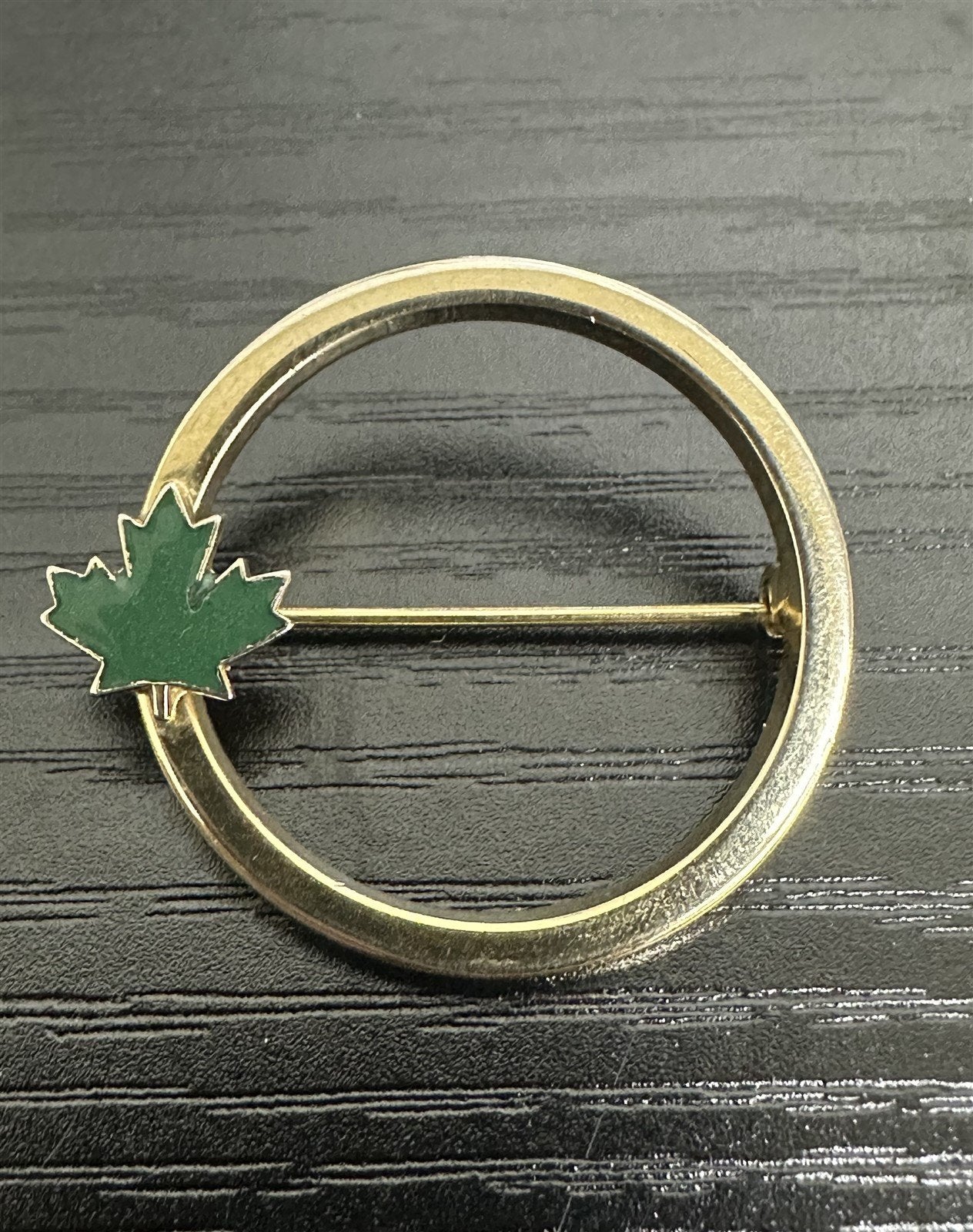 Unsigned Circular Gold-Toned Brooch with a Green Enamel Canadian Maple Leaf